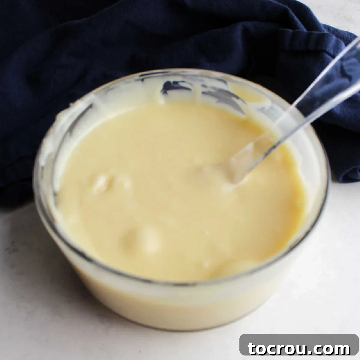 Bowl of melted white chocolate chips and condensed milk.