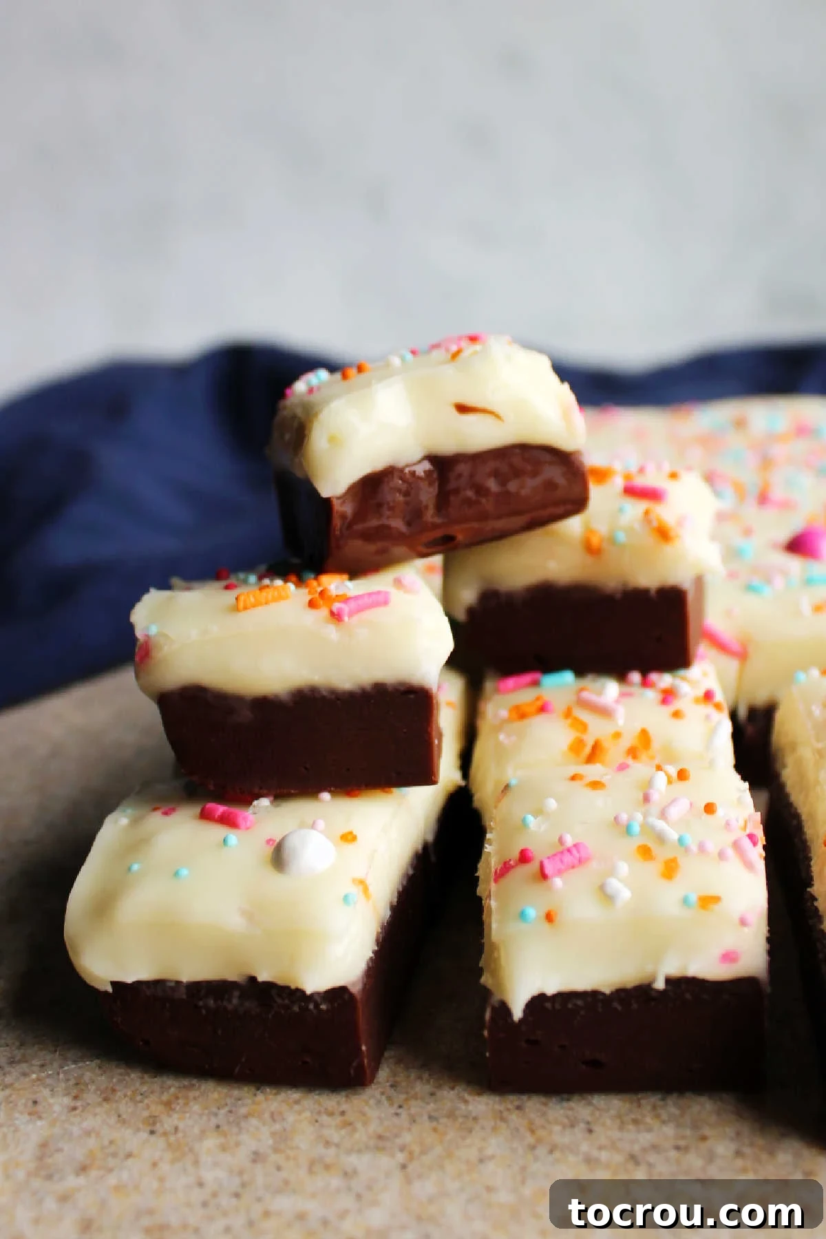 stack of tuxedo fudge with chocolate and vanilla layers, ready to eat.