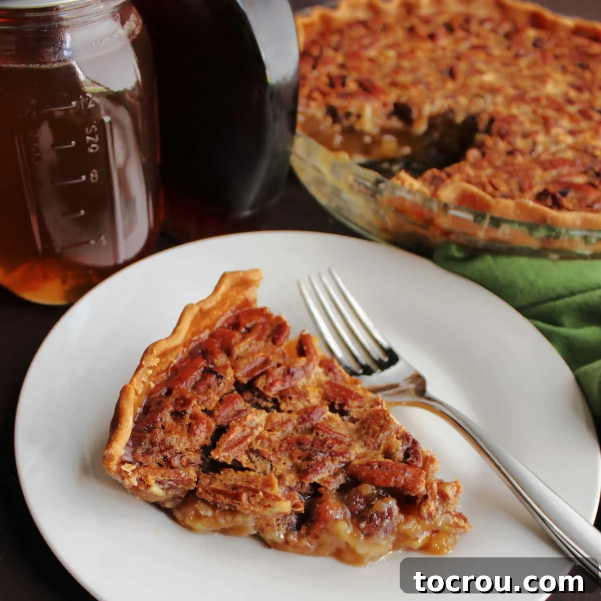 Pure Honey and Maple Pecan Pie 2 Slice of honey maple pecan pie with fork, ready to eat.