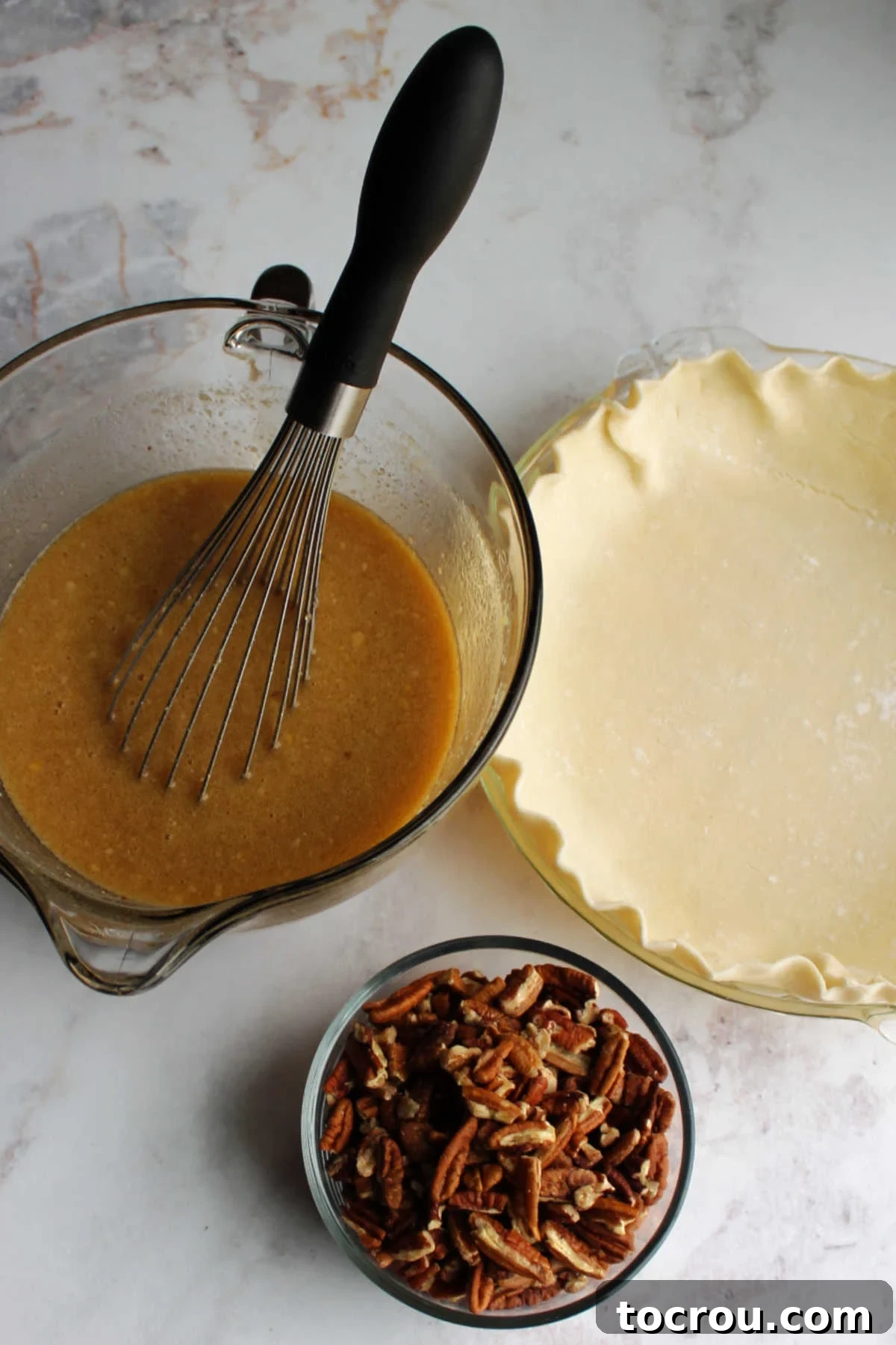 Pure Honey and Maple Pecan Pie 4 Pie crust in pan, bowl of honey maple mixture and bowl of pecans.