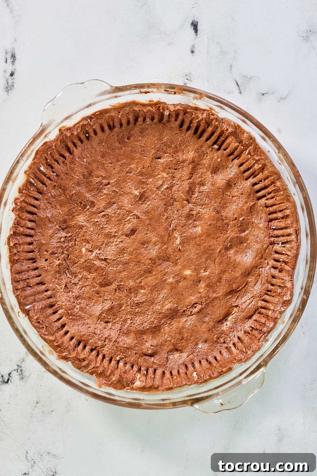 Pure Honey and Maple Pecan Pie 5 Chocolate pie crust in pie plate with edges fluted with a fork, ready for filling.