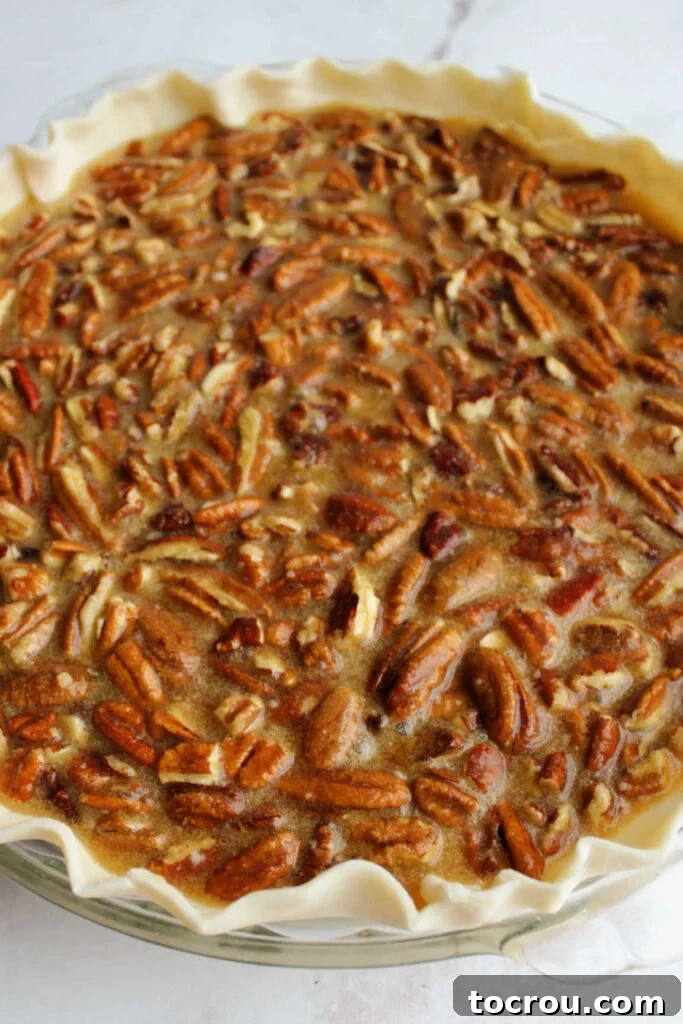 Pure Honey and Maple Pecan Pie 7 pie crust filled with pecans, honey and maple syrup ready to bake.
