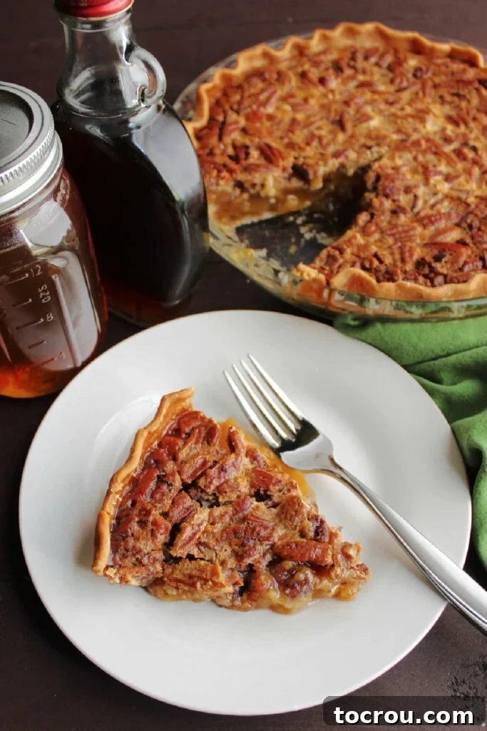 Pure Honey and Maple Pecan Pie 9 Looking down on slice of pecan pie with honey and maple syrup nearby.