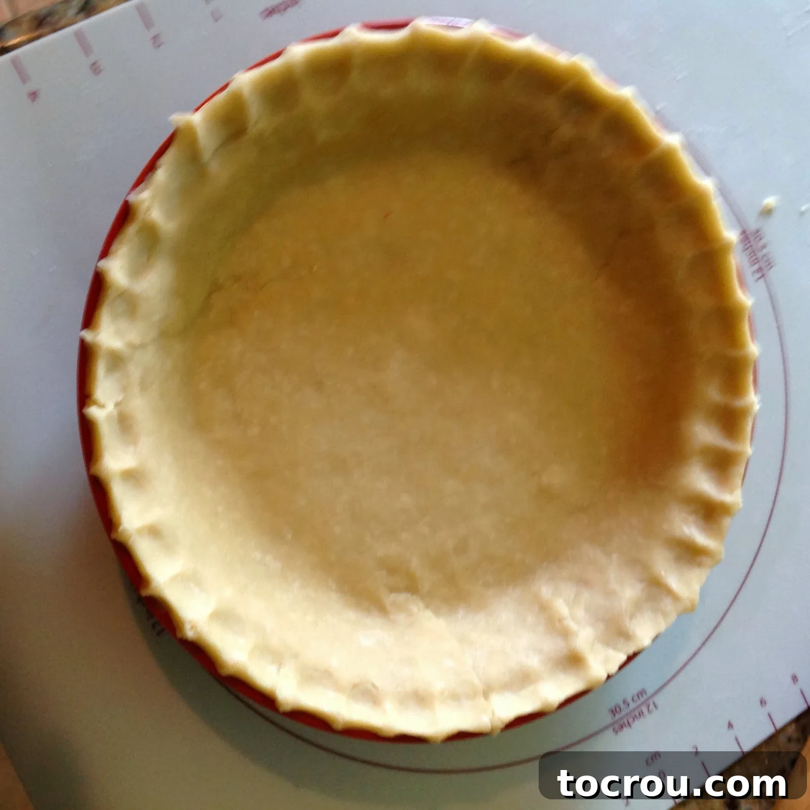 Perfect Flaky Pie Crust Flaky pie crust pastry in pie pan with fluted edges, ready for filling.