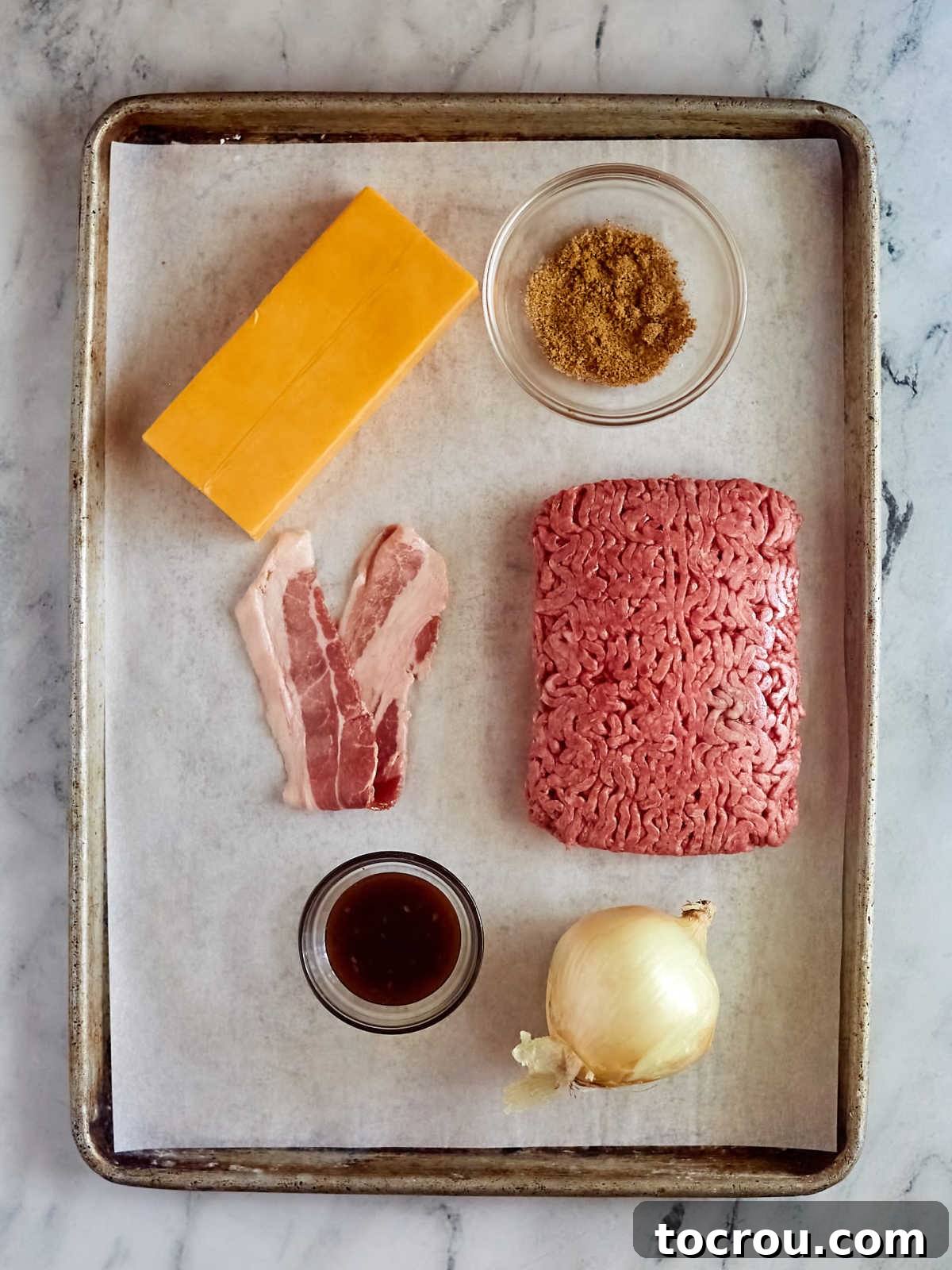 Maw-Maws Unexpected Burger Bliss 3 Ingredients including ground beef, onion, bacon, BBQ sauce, and cheese ready to be made into stuffed hamburgers. High-quality ingredients are key to a delicious Maw-Maw's Hamburger Surprise.