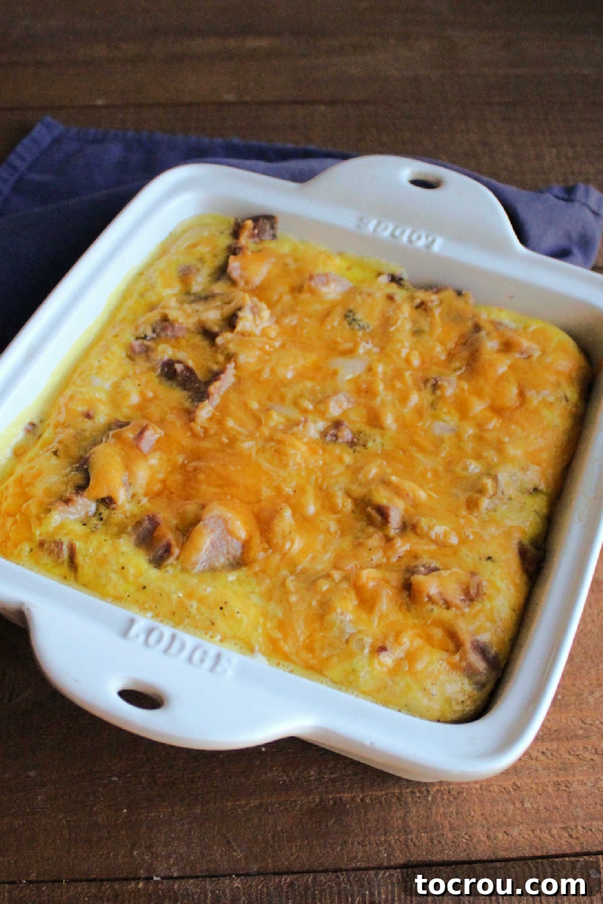 Baked Tater Tot Casserole The perfectly baked tater tot egg casserole, fresh out of the oven, showing how the eggs have beautifully puffed up and expanded to cover all the ingredients in the pan.