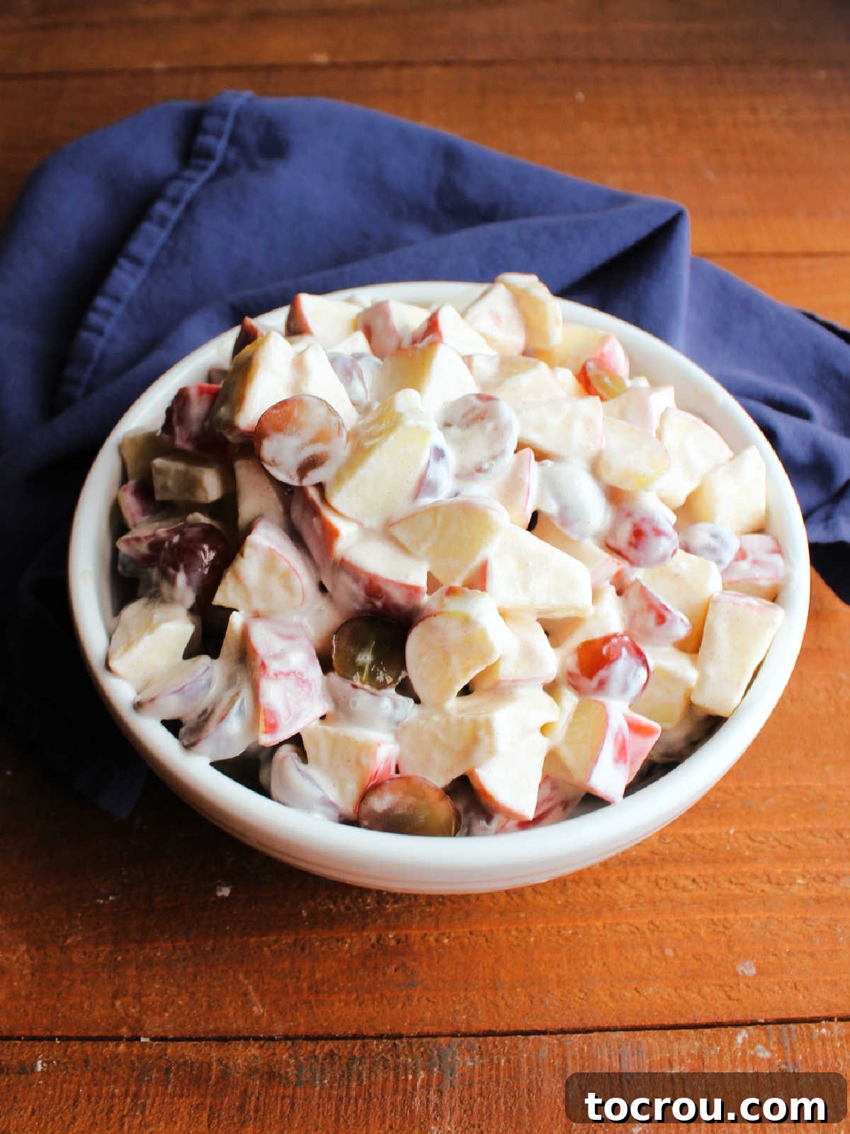 Overhead shot of creamy grape apple salad. Looking down on serving bowl of grape apple salad with creamy yogurt.