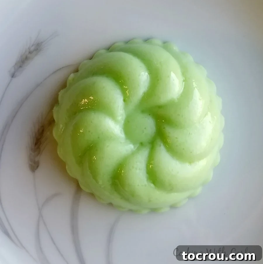 swirly creamy green jello unmolded onto a plate