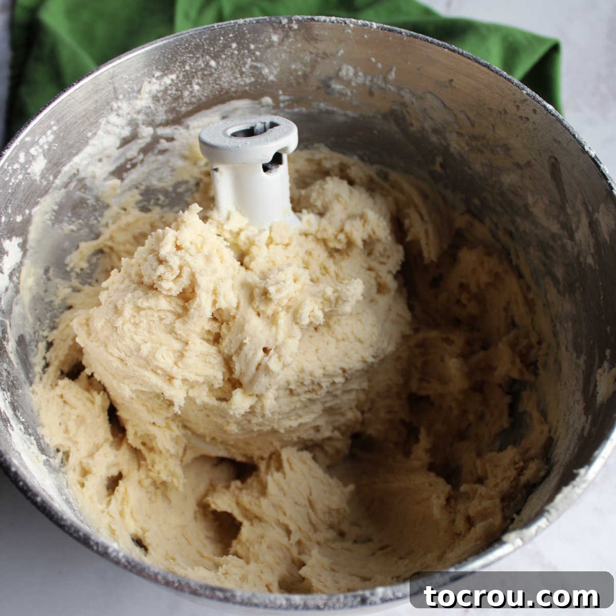 mixer bowl filled with sweetened condensed milk cookie dough.