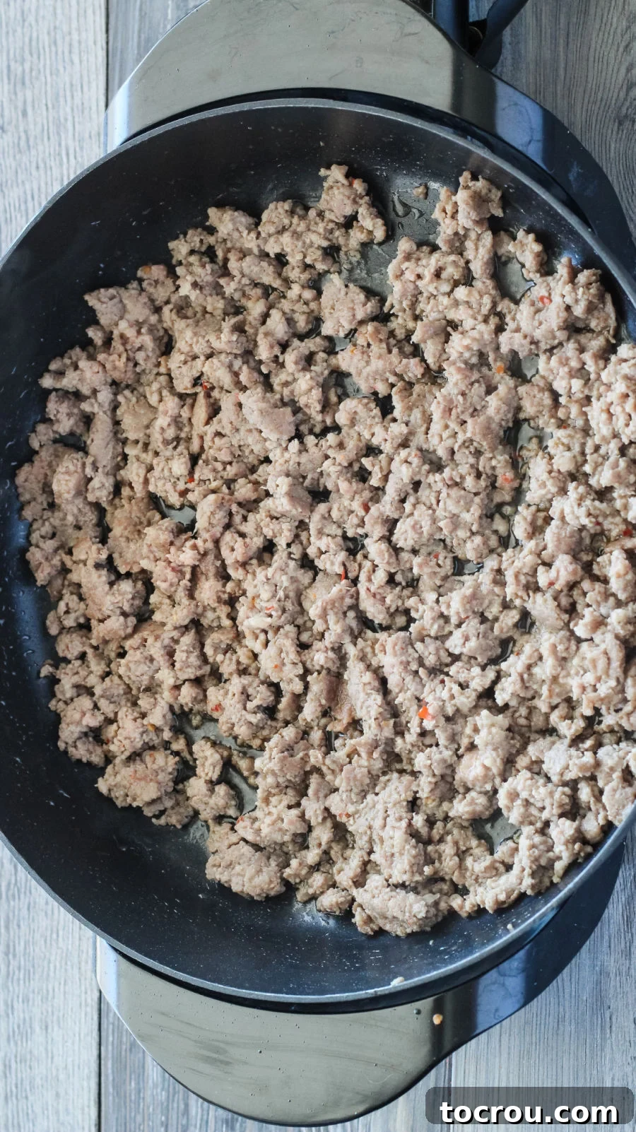 Browned Italian sausage in a large pot, ready for the next ingredients to be added for dinner.